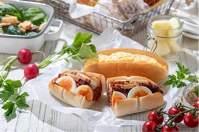 A table filled with an array of sandwiches and additional food items
